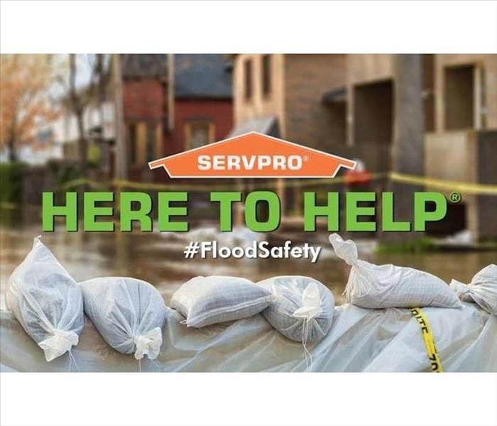 Overview of flood with "Here to Help" and SERVPRO logo