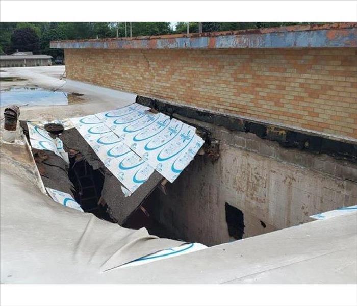 Commercial roof that collapsed from storm damage